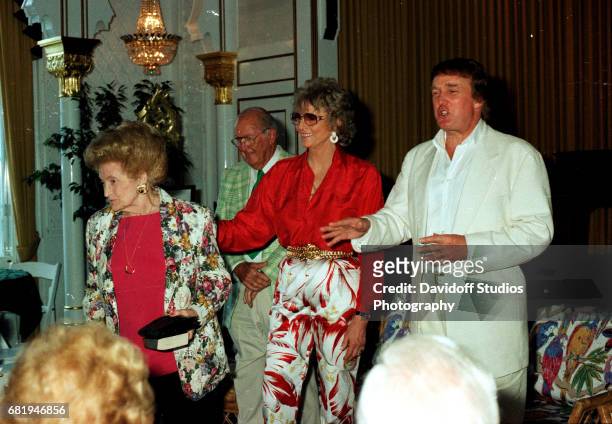 American former competative swimmer Marjorie Post Dye stands with Mary Trump and the latter's son, real estate developer Donald Trump, during an...