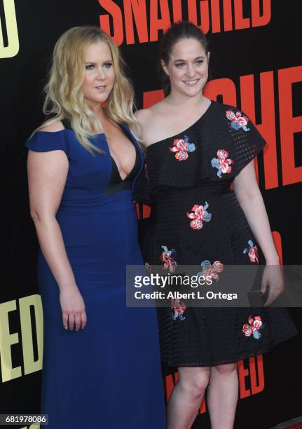 Actress Amy Schumer and sister/Producer/writer Kim Caramele arrive for the Premiere Of 20th Century Fox's "Snatched" held at Regency Village Theatre...