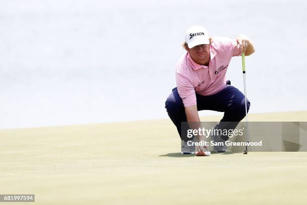 William McGirt of the United States lines up a putt on the 18th green during the first round of THE PLAYERS Championship at the Stadium course at TPC...