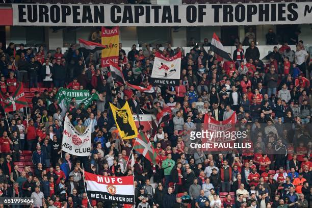Manchester United supporters hold up banners in the crowd ahead of the UEFA Europa League semi-final, second-leg football match between Manchester...
