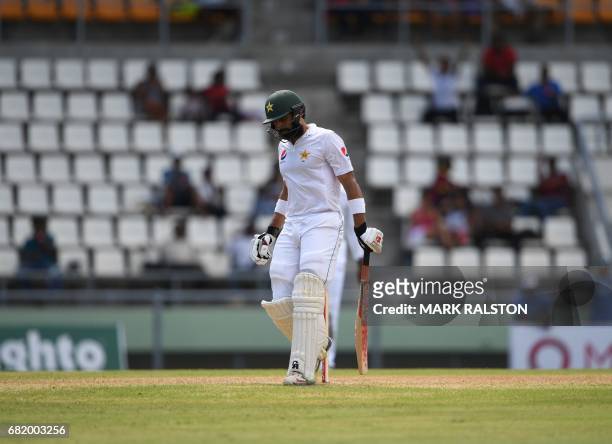 Captain Misbah-ul-Haq of Pakistan leaves the field after getting out for 59 off the bowling of Chase during his final test match, on the second day...