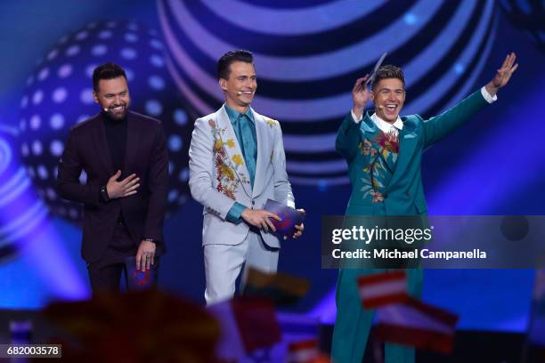 Hosts Timur Miroshnychenko, Oleksandr Skichko and Volodymur Ostapchuk speak on stage during the second semi final of the 62nd Eurovision Song Contest...