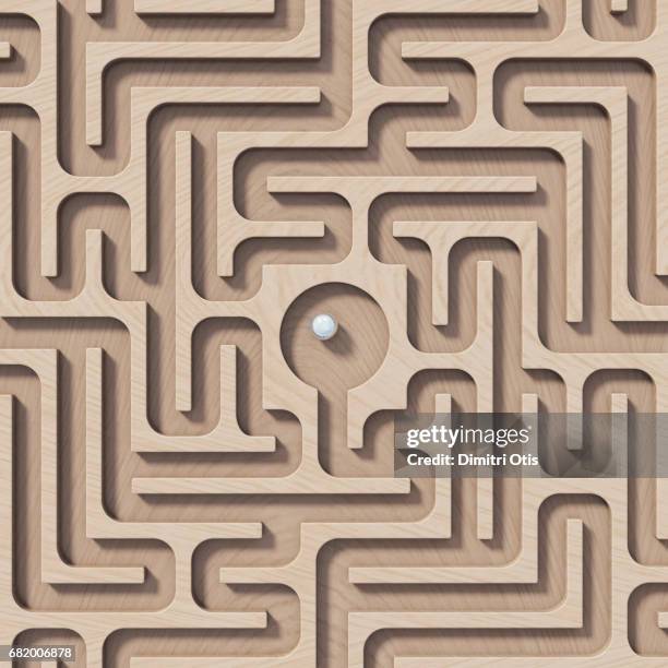 wooden maze with chrome ball in the centre, top view - labirinto imagens e fotografias de stock