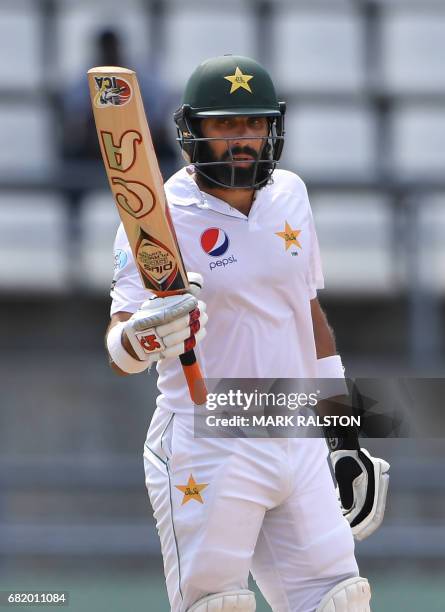 Captain Misbah-ul-Haq of Pakistan acknowledges the crowd after scoring his 50 during his final test match, on the second day of play against the West...