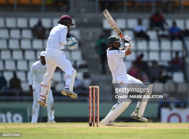 Captain Misbah-ul-Haq of Pakistan plays a cover shot before getting out for 59 off the bowling of Chase during his final test match, on the second...