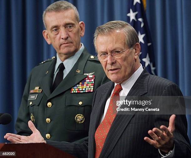 Commander of military operations in Afghanistan Army General Tommy Franks watches as US Secretary of Defense Donald Rumsfeld speaks to the media...