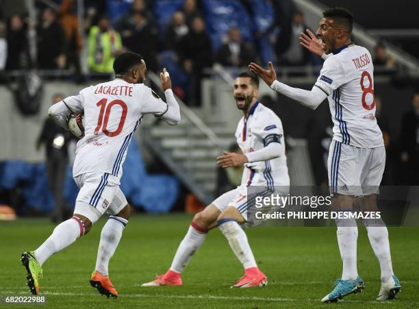 Lyon's French forward Alexandre Lacazette is congratuled by teammates French midfielder Coretin Tolisso and French midfielder Maxime Gonalons after...