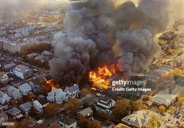 The wreckage of American Airlines flight 587 burns November 12, 2001 in the Rockaway neighborhood of the Queens section of New York City, The Airbus...