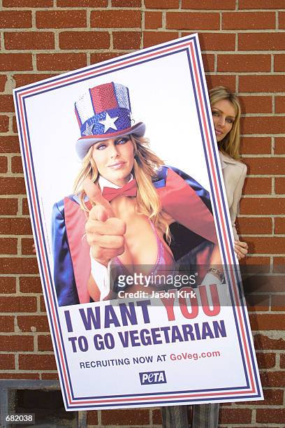 Playboy Playmate Kimberly Hefner poses with a poster for the Ethical Treatment of Animals new ad campaign November 16, 2001 in Culver City, CA. The...