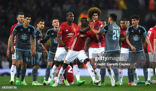 Players from both sides clash in the build up to Eric Bailly of Manchester United and Facundo Roncaglia of Celta Vigo being shown a red card during...