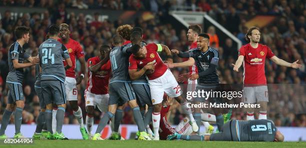 Antonio Valencia of Manchester United clashes with Iago Aspas of Celta Vigo while Paul Pogba clashes with Facundo Roncaglia during the UEFA Europa...