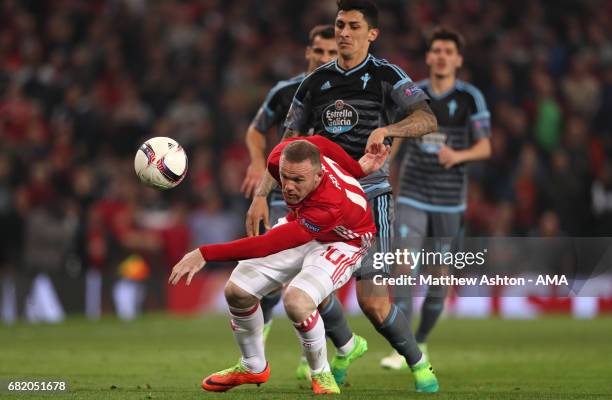 Wayne Rooney of Manchester United battles for the ball with Pablo Hernandez of Celta Vigo during the UEFA Europa League, semi final second leg match,...