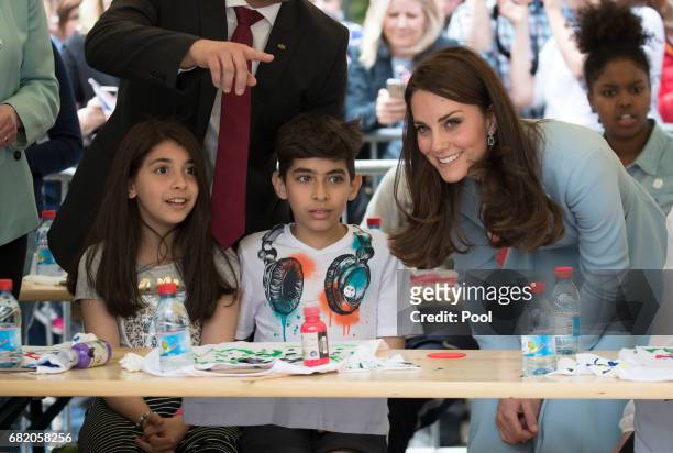 Catherine, Duchess of Cambridge meets children as she visits Place Clairefontaine during a one day visit to Luxembourg on May 11, 2017 in Luxembourg,...