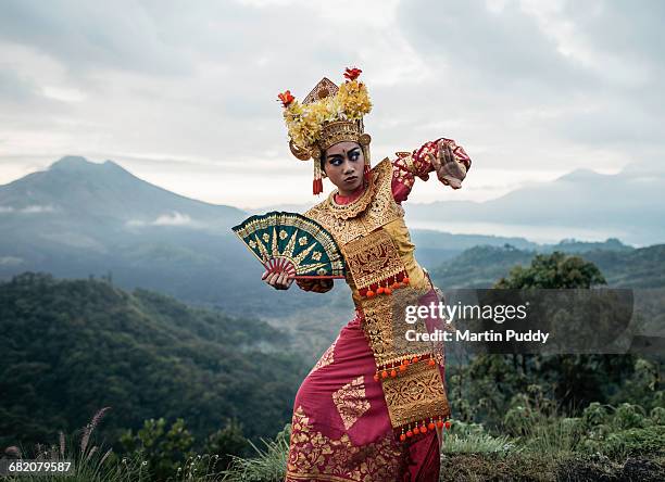traditional legong dancer infront of volcano - bali dancing stock pictures, royalty-free photos & images