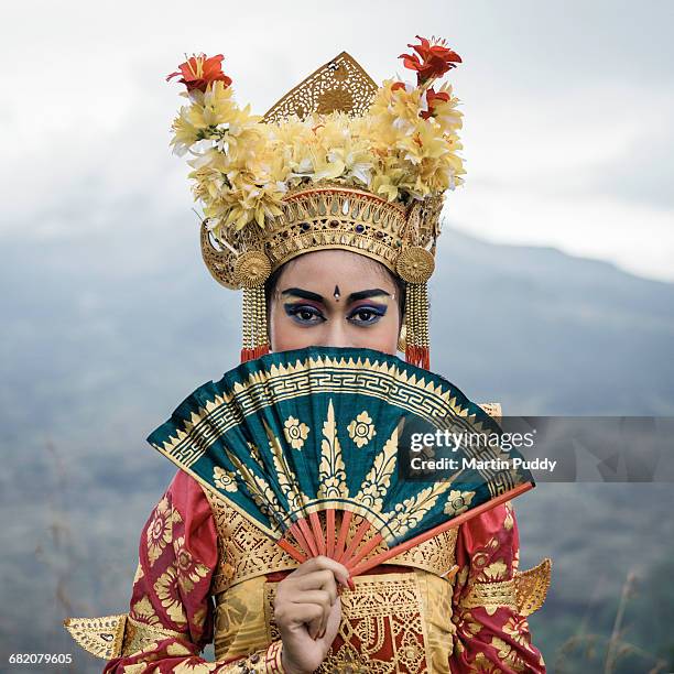 legong dancer on hillside infront of volcano - bali dancing stock pictures, royalty-free photos & images