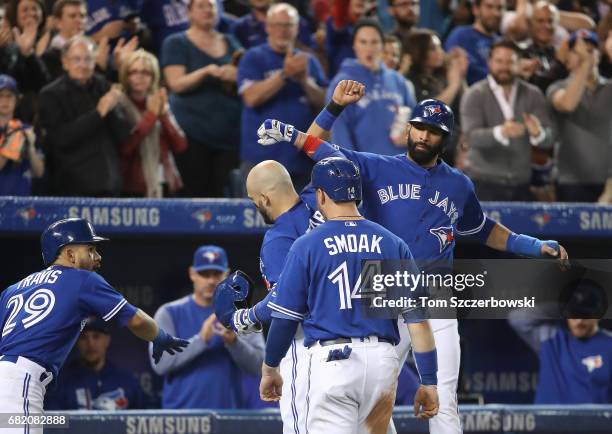 Steve Pearce of the Toronto Blue Jays is congratulated by Jose Bautista after hitting a three-run home run in the fifth inning during MLB game action...