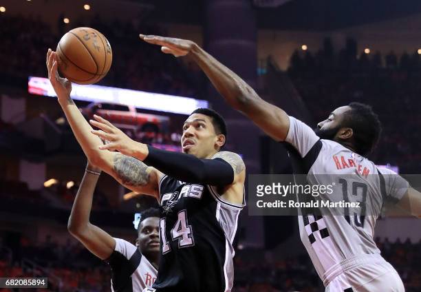 Danny Green of the San Antonio Spurs drives between James Harden and Clint Capela of the Houston Rockets during Game Six of the NBA Western...