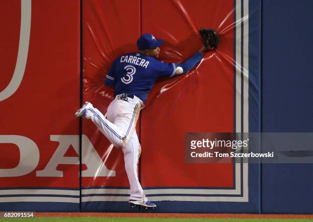 Ezequiel Carrera of the Toronto Blue Jays cannot catch a double hit by Nelson Cruz of the Seattle Mariners in the eighth inning during MLB game...