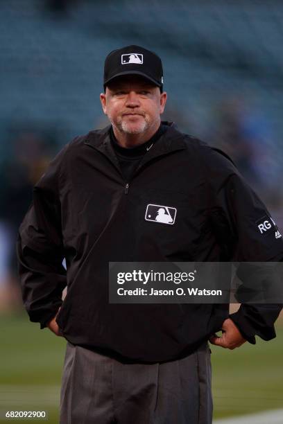 Umpire Ron Kulpa stands on the field before the game between the Oakland Athletics and the Los Angeles Angels of Anaheim at the Oakland Coliseum on...