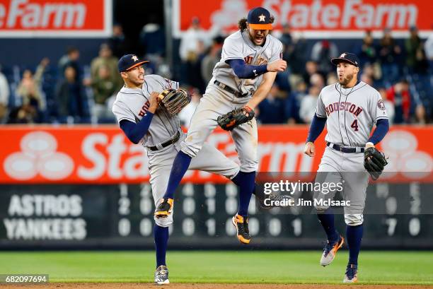Carlos Correa, Jake Marisnick and George Springer of the Houston Astros celebrate after defeating the New York Yankees at Yankee Stadium on May 11,...