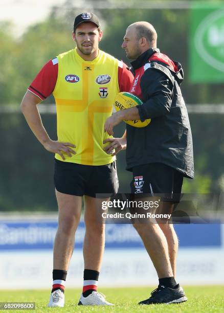 Paddy McCartin of the Saints speaks to Aaron Hamill during a St Kilda Saints AFL training session at Trevor Barker Beach Oval on May 12, 2017 in...