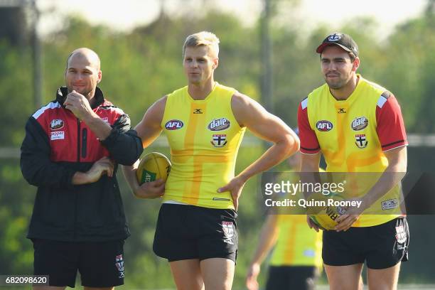 Aaron Hamill, Nick Riewoldt and Paddy McCartin of the Saints look on during a St Kilda Saints AFL training session at Trevor Barker Beach Oval on May...