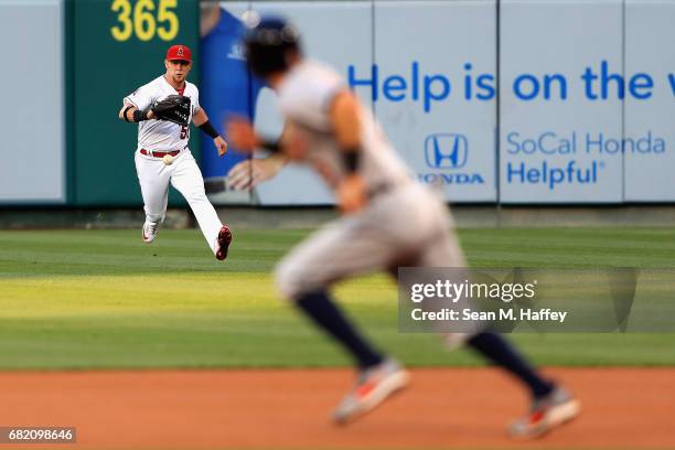 Kole Calhoun of the Los Angeles Angels of Anaheim fields a single hit by Nicholas Castellanos as Ian Kinsler of the Detroit Tigers runs to second...
