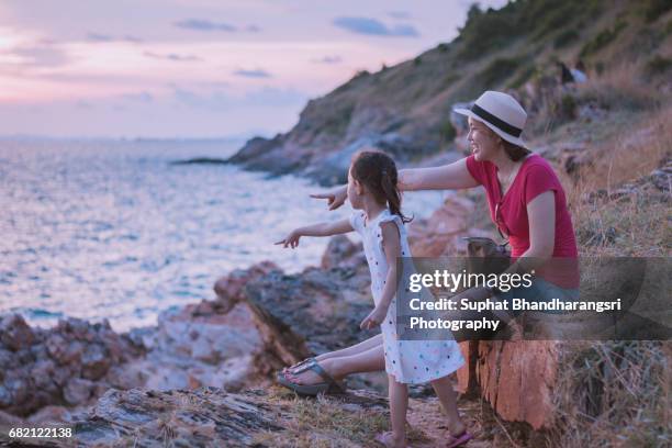 mother & daughter enjoying together before the sunset - suphat bhandharangsri stock pictures, royalty-free photos & images