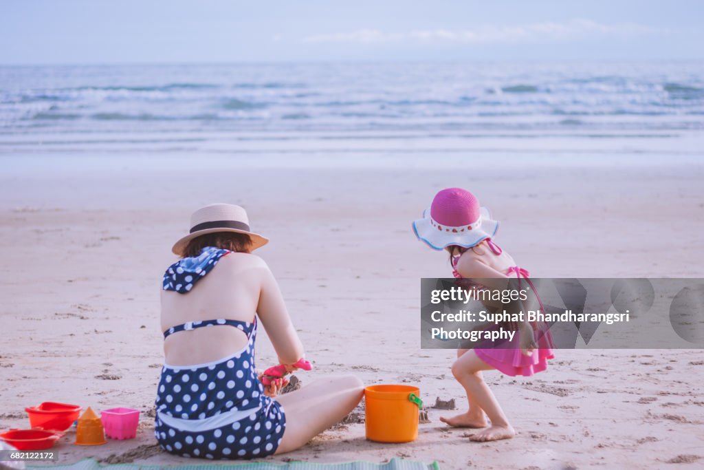 Mother and daughter playing sand toys