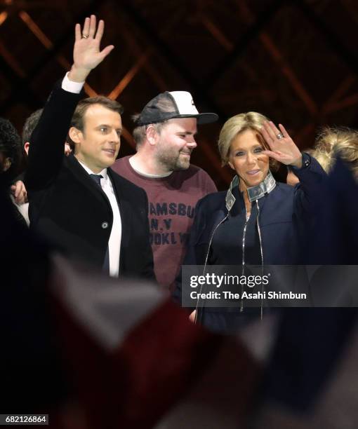 Leader of 'En Marche !' Emmanuel Macron and his wife Brigitte to supporters after winning the French Presidential Election, at The Louvre on May 7,...