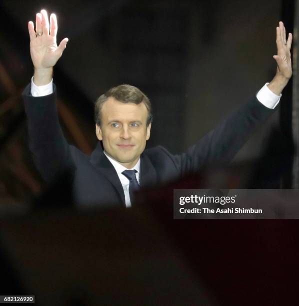 Leader of 'En Marche !' Emmanuel Macron waves to supporters after winning the French Presidential Election, at The Louvre on May 7, 2017 in Paris,...