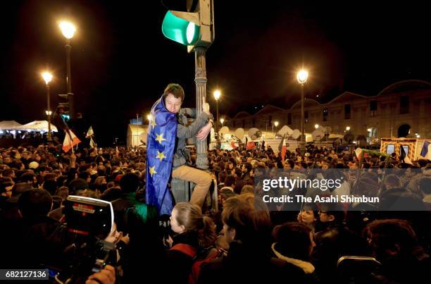 Supporters of Emmanuel Macron celebrate after his win in the French Presidential Election, at The Louvre on May 7, 2017 in Paris, France. Pro-EU...