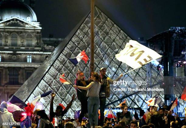 Supporters of Emmanuel Macron celebrate after his win in the French Presidential Election, at The Louvre on May 7, 2017 in Paris, France. Pro-EU...