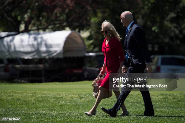 White House adviser Kellyanne Conway and Director of Oval Office operations Keith Schiller follow the president to board Marine One on the South Lawn...