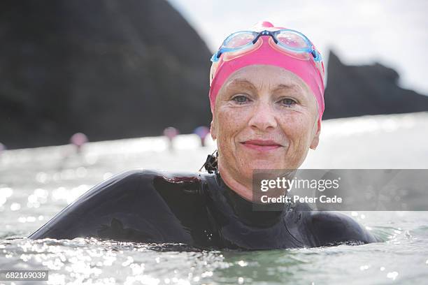 older woman swimming in the sea - swimming cap stock pictures, royalty-free photos & images