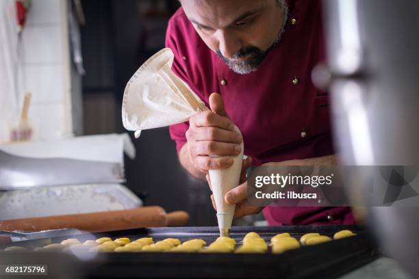 italiaans gebak maken van patisserie bakken banketbakker: met behulp van sac een poche voor het vormgeven van gebak - eclair stockfoto's en -beelden