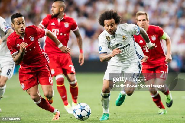 Marcelo Vieira Da Silva of Real Madrid battles for the ball with Thiago of FC Bayern Munich during their 2016-17 UEFA Champions League Quarter-finals...