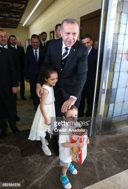Turkish President Recep Tayyip Erdogan gives Turkish identity cards to seven-year-old Syrian girl Bana Al-Abed, and her family after they took...