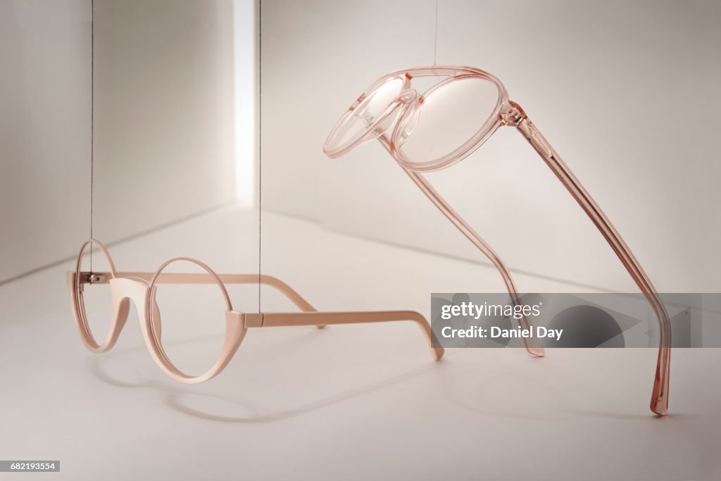 Groups of reading glasses hanging and suspended