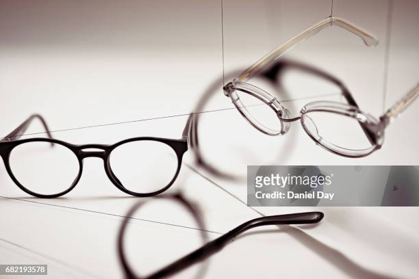 groups of reading glasses hanging and suspended - leesbril stockfoto's en -beelden
