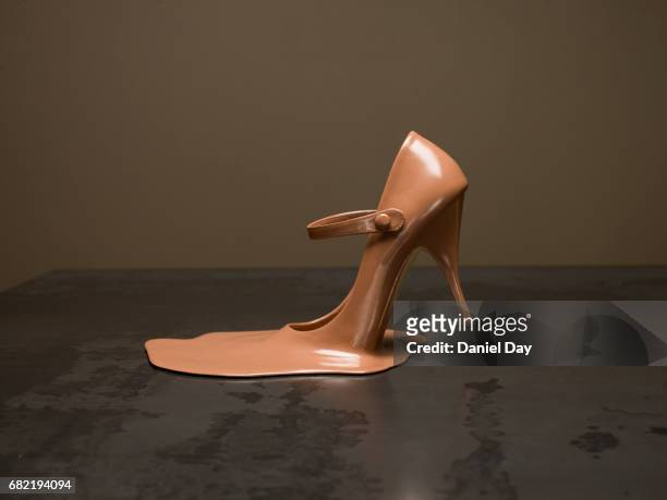 melted shoe on a metal table - metallic shoe fotografías e imágenes de stock
