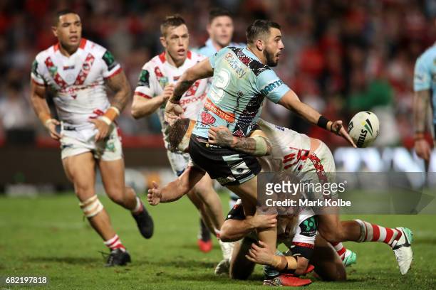 Jack Bird of the Sharks passes as he is tackled during the round 10 NRL match between the St George Illawarra Dragons and the Cronulla Sharks at UOW...