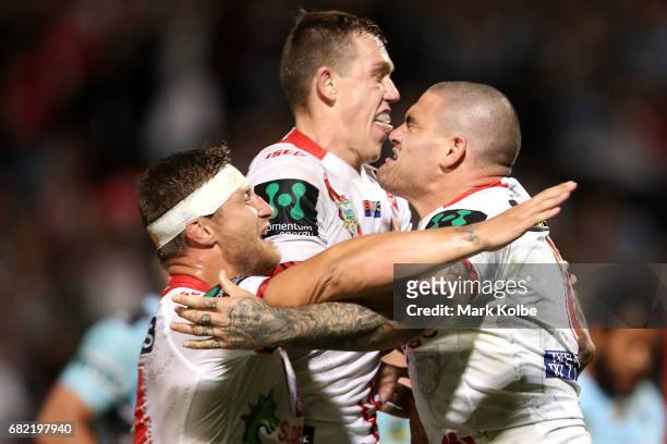 Tariq Sims and Cameron McInnes of the Dragons celebrate with Russell Packer of the Dragons as he celebrates scoring a try during the round 10 NRL...