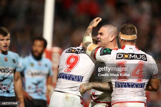 Tariq Sims and Cameron McInnes of the Dragons celebrate with Russell Packer of the Dragons as he celebrates scoring a try during the round 10 NRL...