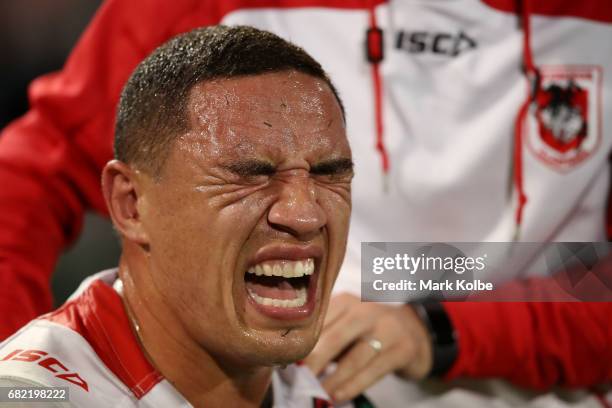 Tyson Frizell of the Dragons grimaces as he receieves attention from the trainer on the bench during the round 10 NRL match between the St George...