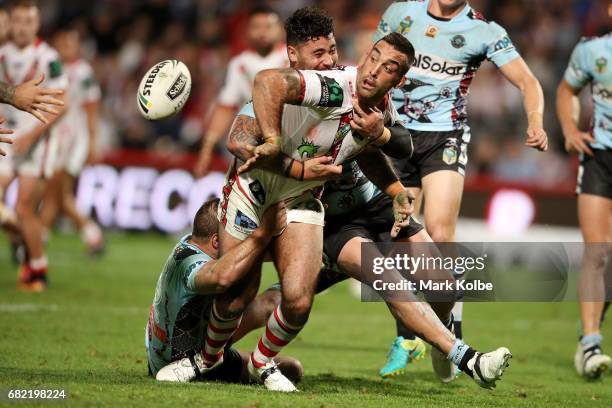 Paul Vaughan of the Dragons passes as he is tackled to Russell Packer of the Dragons to score a try during the round 10 NRL match between the St...