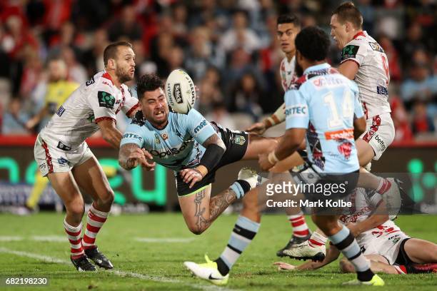 Andrew Fifita of the Sharks passes as he is tackled during the round 10 NRL match between the St George Illawarra Dragons and the Cronulla Sharks at...
