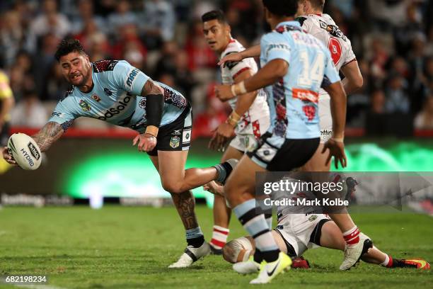 Andrew Fifita of the Sharks passes as he is tackled during the round 10 NRL match between the St George Illawarra Dragons and the Cronulla Sharks at...