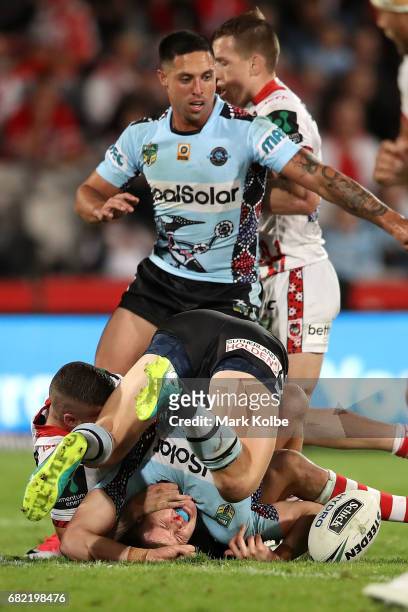 Jayden Brailey of the Sharks falls akwardly as he is tackled during the round 10 NRL match between the St George Illawarra Dragons and the Cronulla...