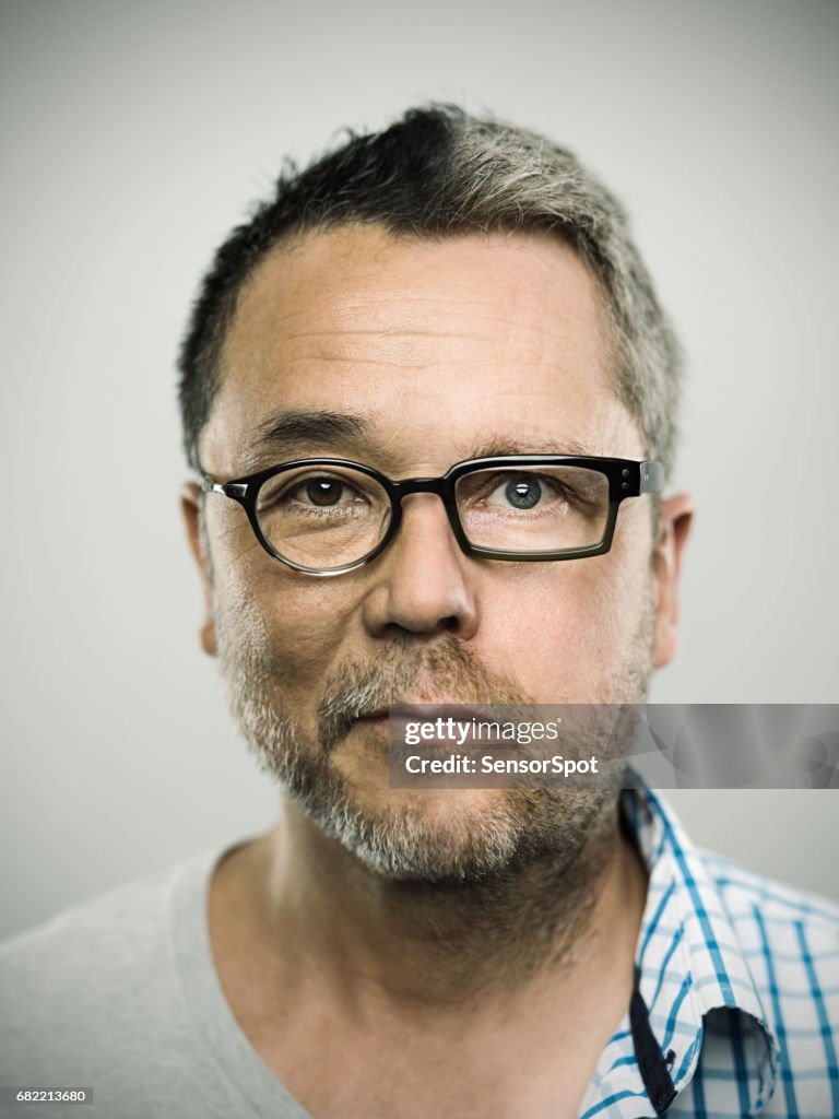 Two faced man against gray background